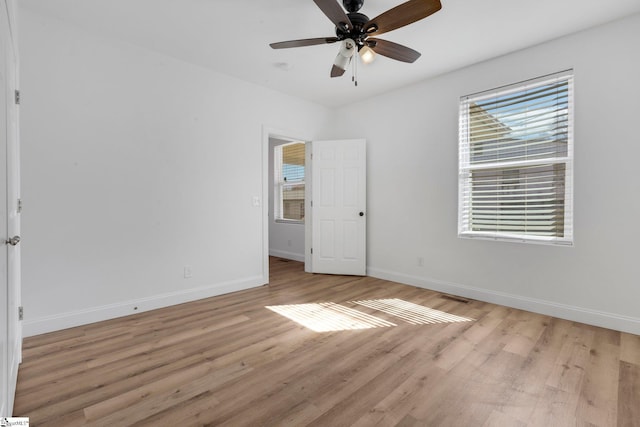 unfurnished bedroom with light wood-type flooring, baseboards, and a ceiling fan