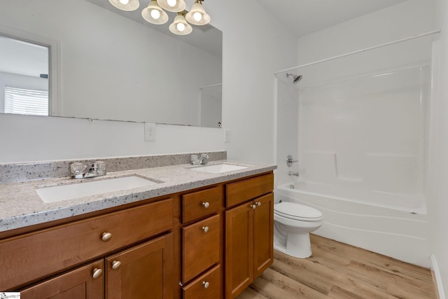 bathroom featuring wood finished floors, a sink, shower / tub combination, and double vanity