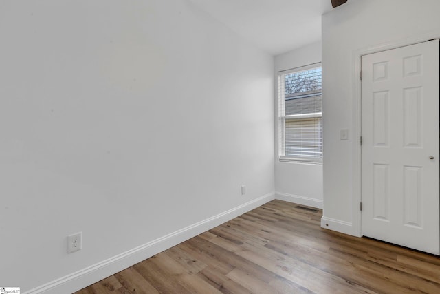 unfurnished bedroom featuring light wood-style floors, visible vents, and baseboards