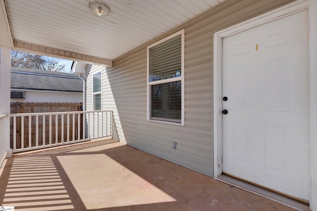 exterior space with covered porch and fence