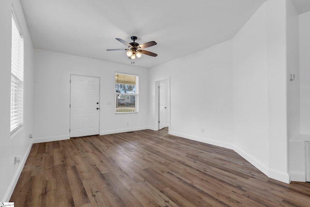 interior space with ceiling fan, baseboards, and wood finished floors