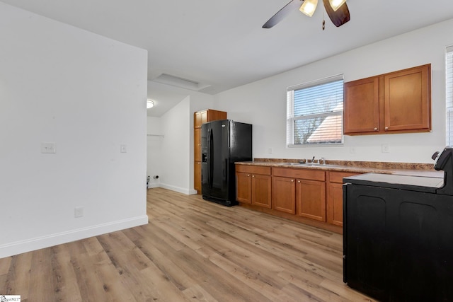 kitchen with stove, a sink, light wood-type flooring, brown cabinets, and black refrigerator with ice dispenser