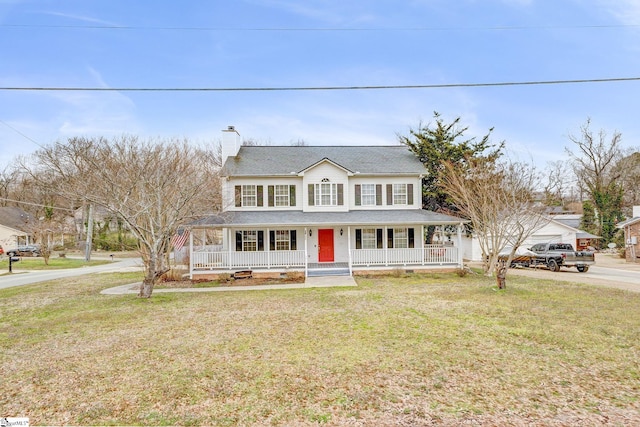 country-style home with a porch, a chimney, and a front lawn