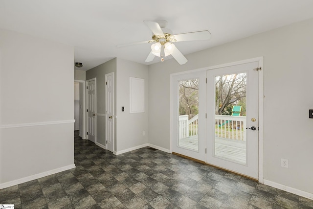 entryway with stone finish flooring, ceiling fan, and baseboards