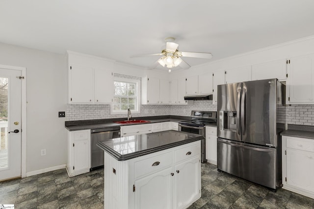 kitchen featuring stainless steel appliances, dark countertops, white cabinets, and under cabinet range hood