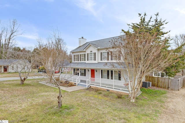 view of front of property featuring a chimney, fence, a porch, and a front yard