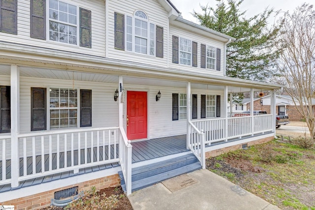 view of front of home with covered porch and crawl space