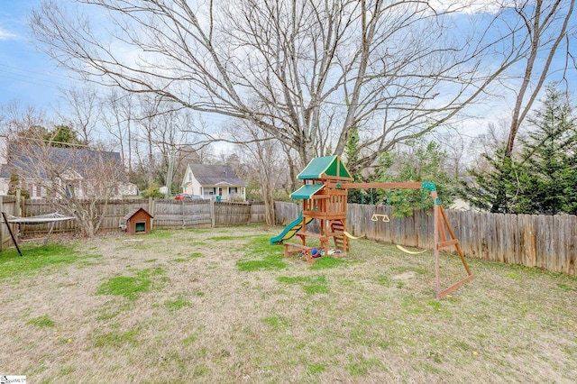 view of yard with a playground and a fenced backyard