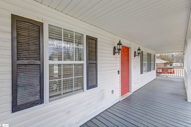 wooden terrace featuring covered porch