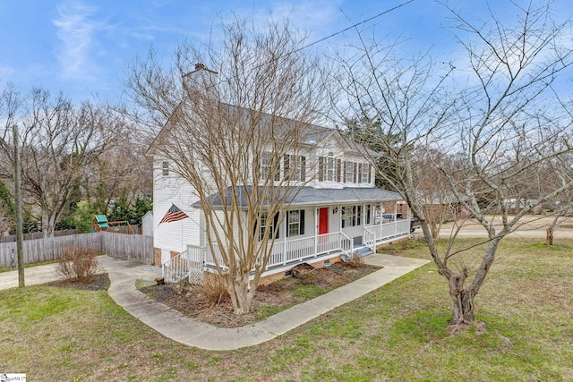 view of front facade featuring a front yard, covered porch, fence, and a chimney