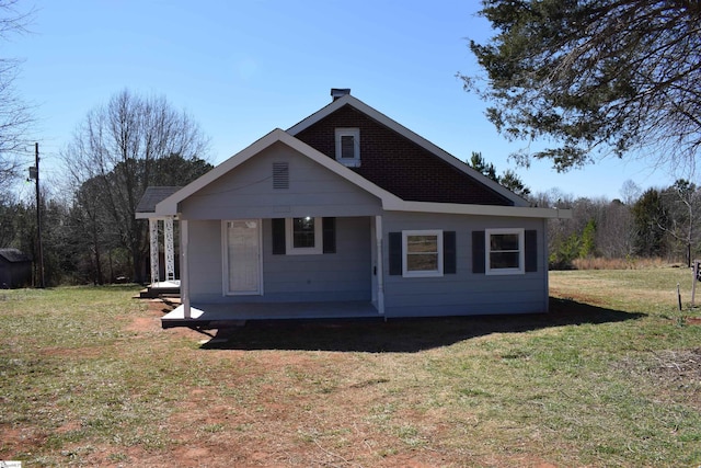 back of house featuring a yard