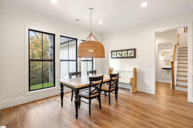 dining room with recessed lighting, baseboards, light wood finished floors, and stairs