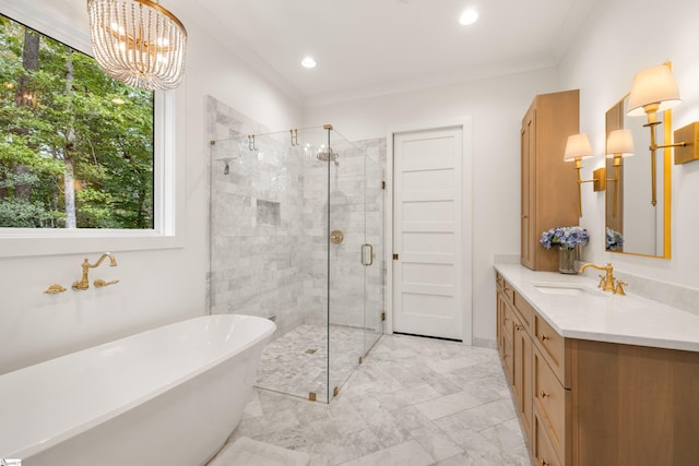 bathroom with a stall shower, crown molding, a freestanding bath, and vanity