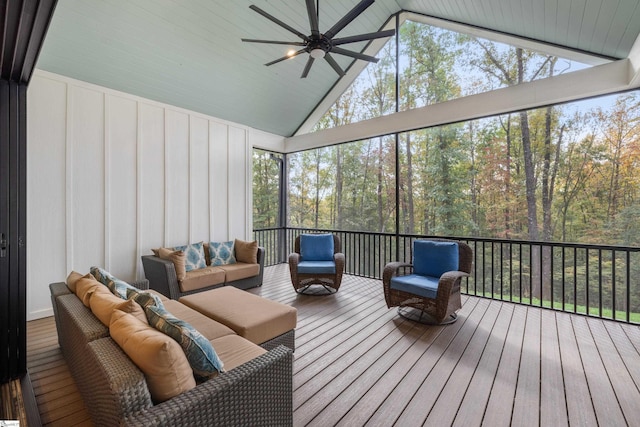 sunroom with a ceiling fan, a wealth of natural light, and lofted ceiling