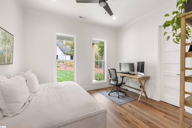 bedroom with ornamental molding, wood finished floors, visible vents, and recessed lighting