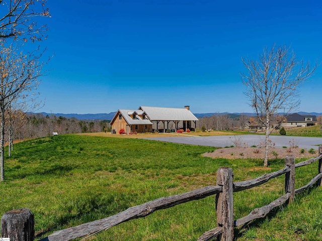 view of yard with a mountain view and driveway