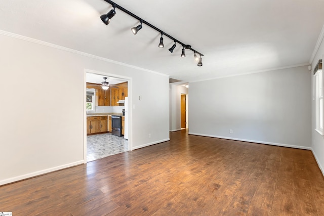 unfurnished living room with dark wood-style flooring, crown molding, and baseboards