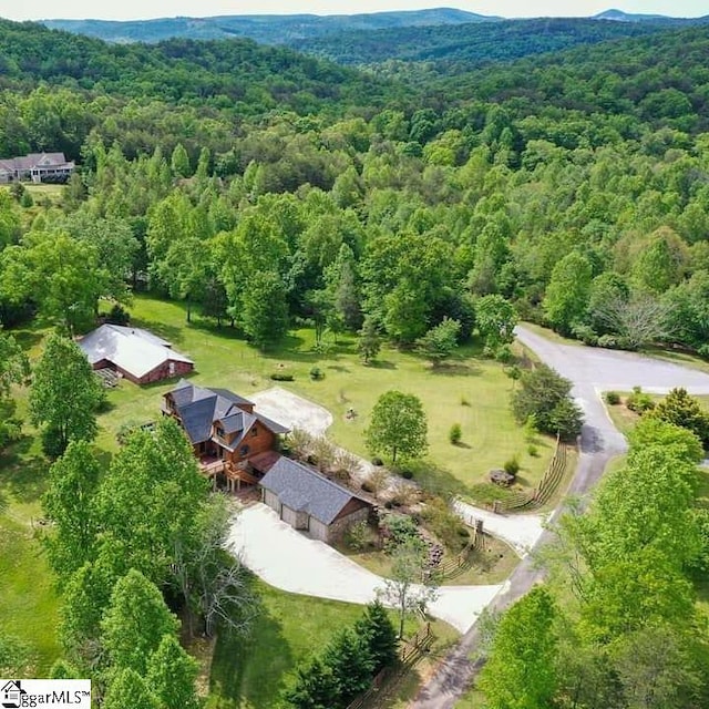 birds eye view of property with a wooded view