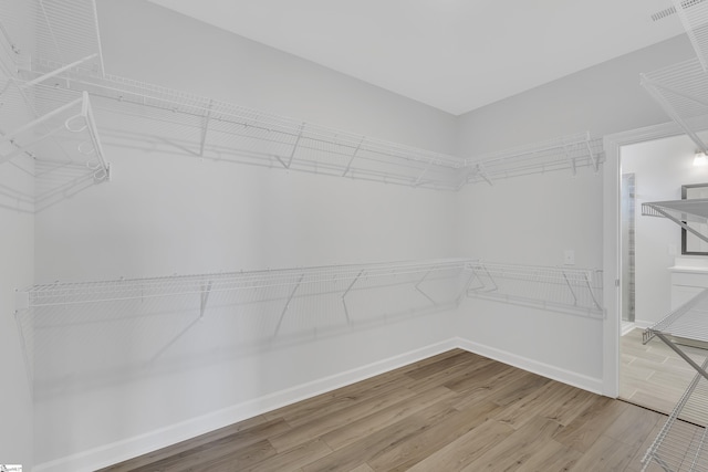 spacious closet with wood finished floors