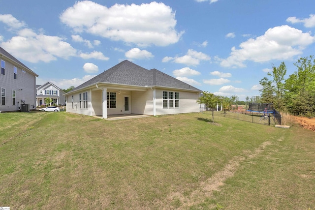 110 Woodcross Dr, Simpsonville, SC 29681 - back of property with cooling unit, a trampoline, a patio area, and a lawn