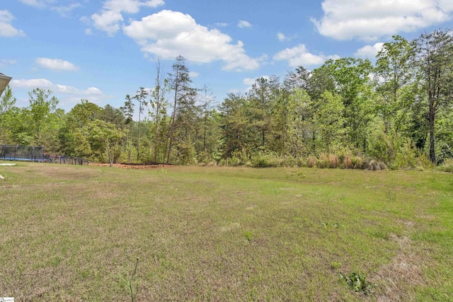 110 Woodcross Dr, Simpsonville, SC 29681 - view of yard featuring a trampoline and a view of trees