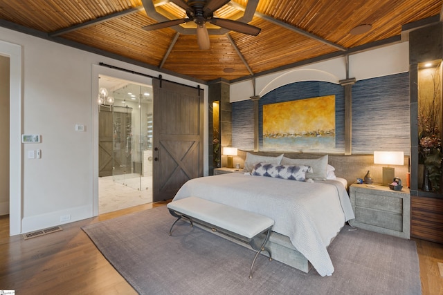 bedroom featuring a barn door, visible vents, lofted ceiling, wood ceiling, and wood finished floors