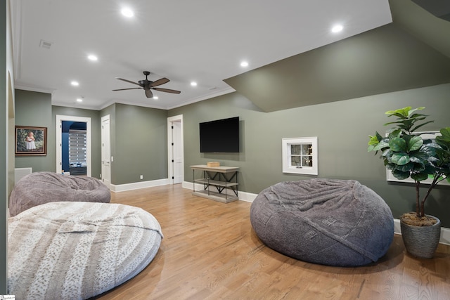 living room with ornamental molding, light wood-type flooring, recessed lighting, and baseboards