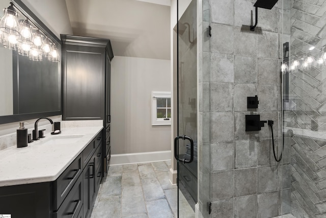 full bathroom with a stall shower, vanity, and baseboards