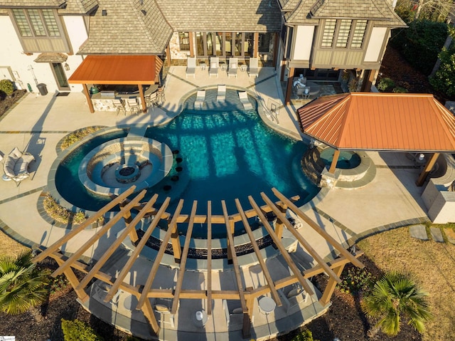 community pool featuring a patio area and a jacuzzi