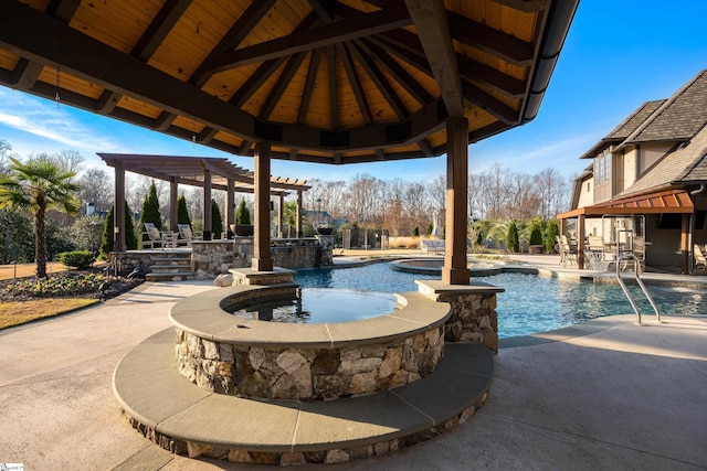 view of swimming pool with a patio area and a pool with connected hot tub