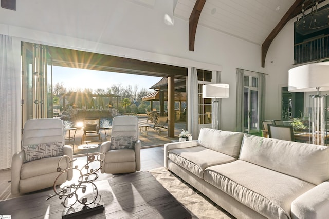 living room with high vaulted ceiling and beam ceiling