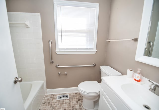 bathroom with bathing tub / shower combination, visible vents, toilet, vanity, and baseboards