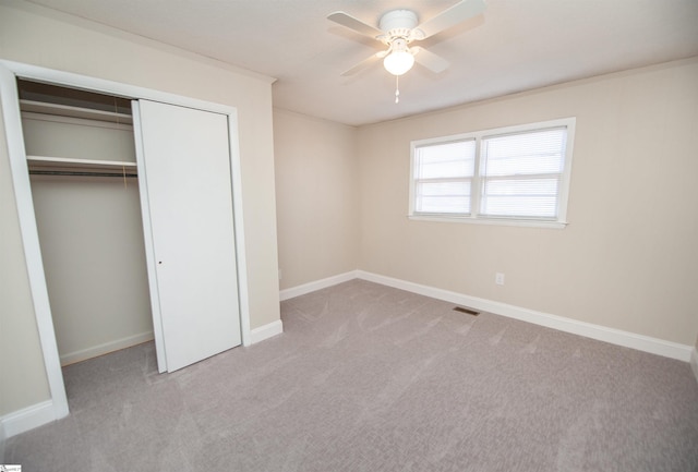 unfurnished bedroom with a closet, carpet flooring, and baseboards