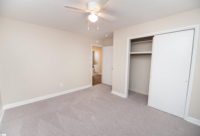 unfurnished bedroom with a closet, carpet flooring, ceiling fan, and baseboards