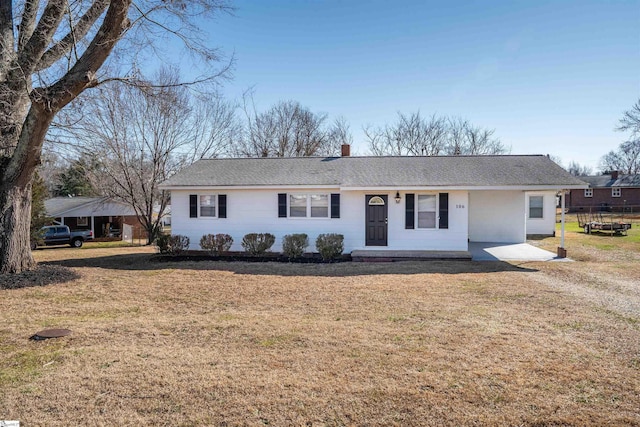 single story home featuring a chimney and a front yard