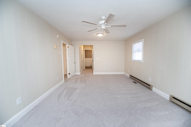 spare room featuring light carpet, ceiling fan, baseboard heating, and baseboards