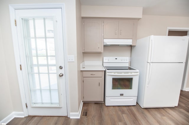 kitchen featuring visible vents, light countertops, wood finished floors, white appliances, and under cabinet range hood