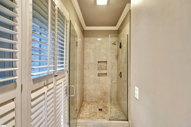 bathroom featuring radiator, crown molding, and a shower stall