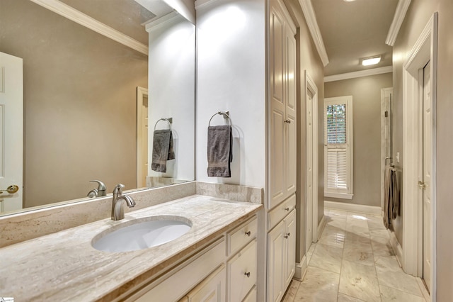 bathroom featuring ornamental molding, vanity, and baseboards