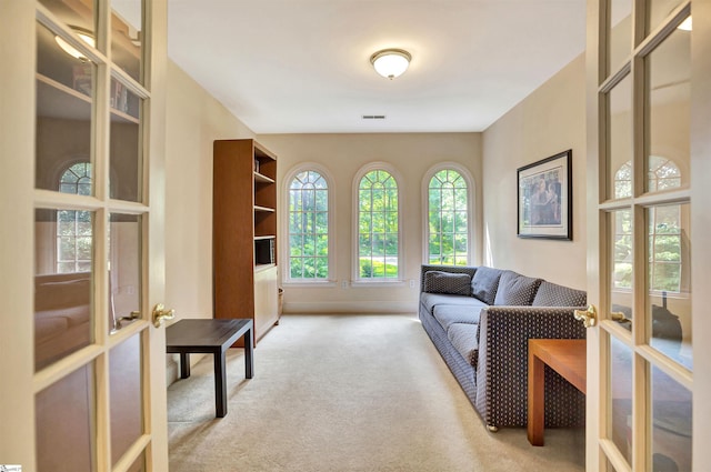 interior space featuring light carpet, french doors, and visible vents