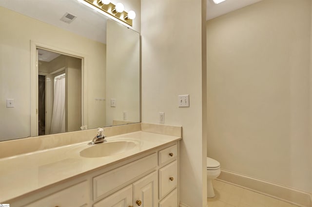 bathroom featuring baseboards, visible vents, vanity, and toilet