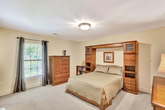 bedroom featuring light carpet, visible vents, and baseboards