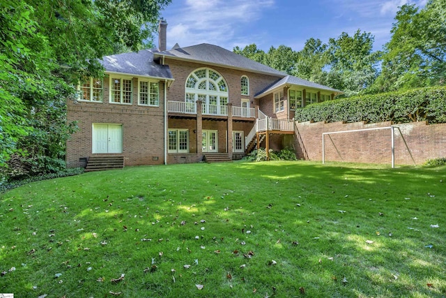 rear view of house featuring a chimney, crawl space, stairs, a yard, and brick siding