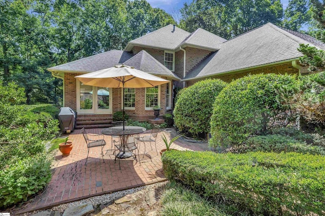 view of patio / terrace featuring entry steps and a grill