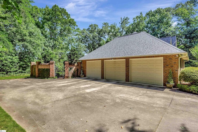 garage featuring concrete driveway