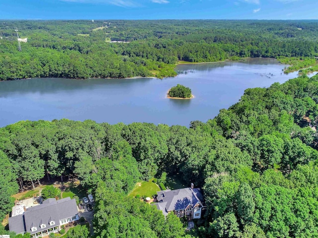 drone / aerial view featuring a water view and a wooded view