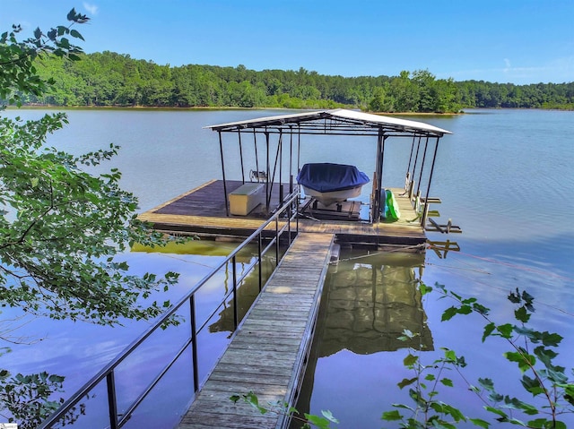 view of dock featuring a water view and a view of trees