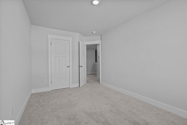 unfurnished bedroom with carpet flooring and baseboards