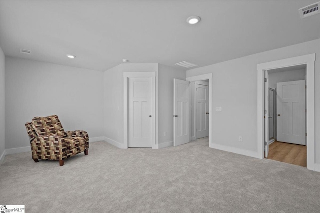 living area with recessed lighting, carpet flooring, visible vents, and baseboards