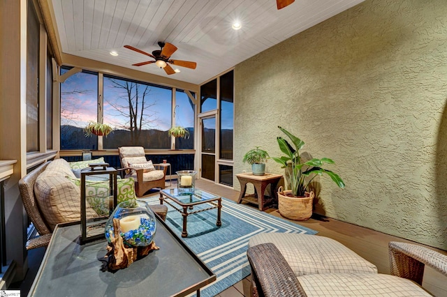 sunroom with ceiling fan and wood ceiling